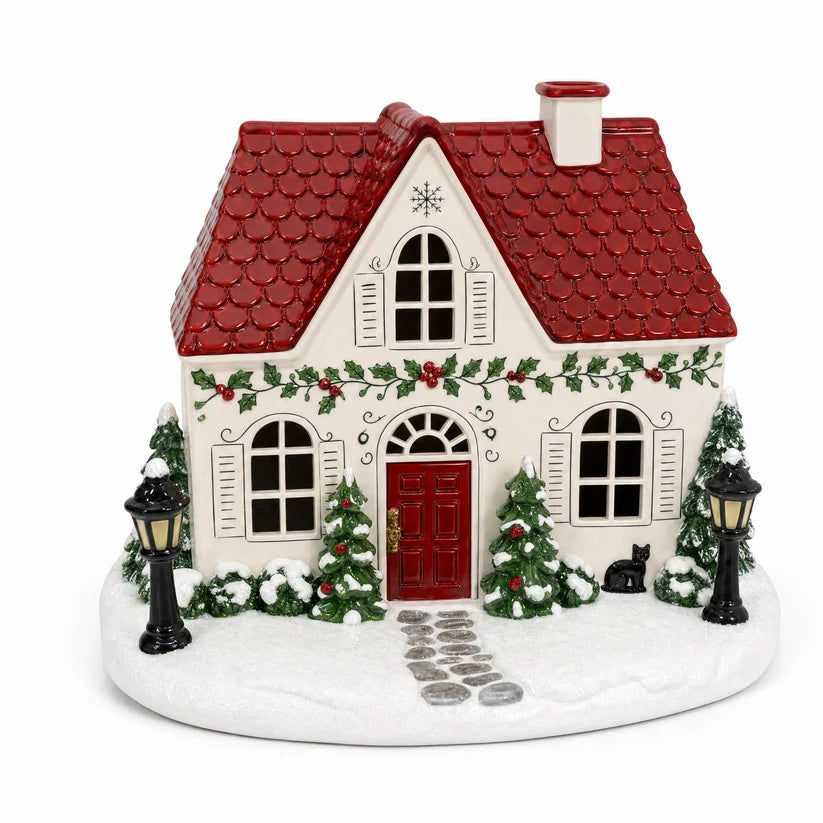 Red-roof Christmas cottage diffuser with snowy trees wreath decorations and vintage holiday detailing