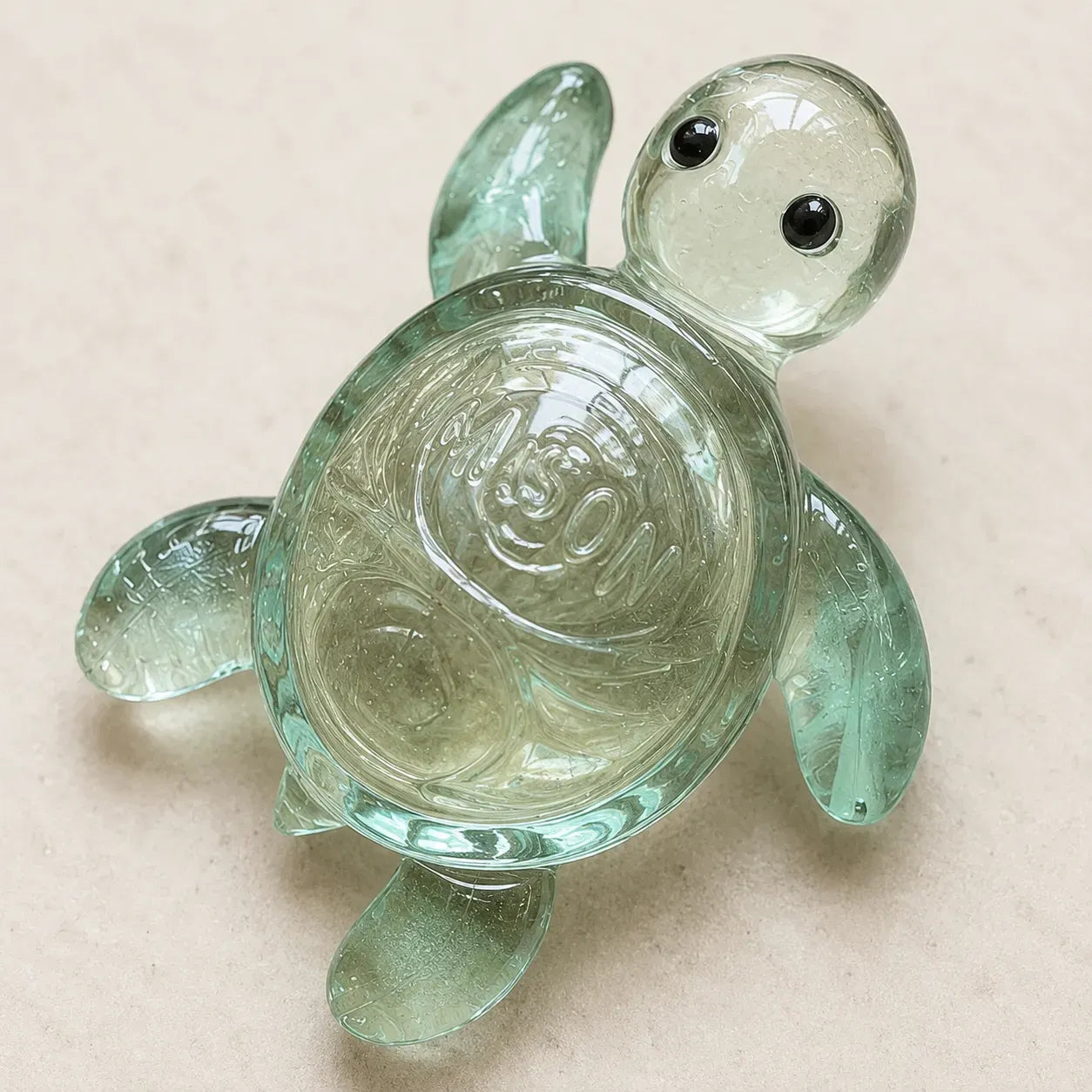 Close-up of translucent green turtle glass figurine with sculpted shell and eyes
