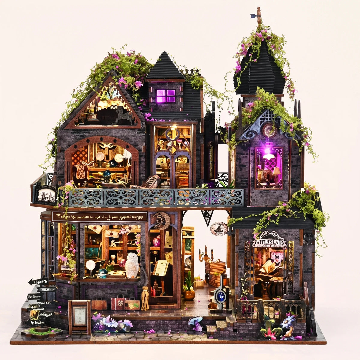 The Witch's Lair DIY miniature gothic mansion kit glowing amber and violet on a blush background